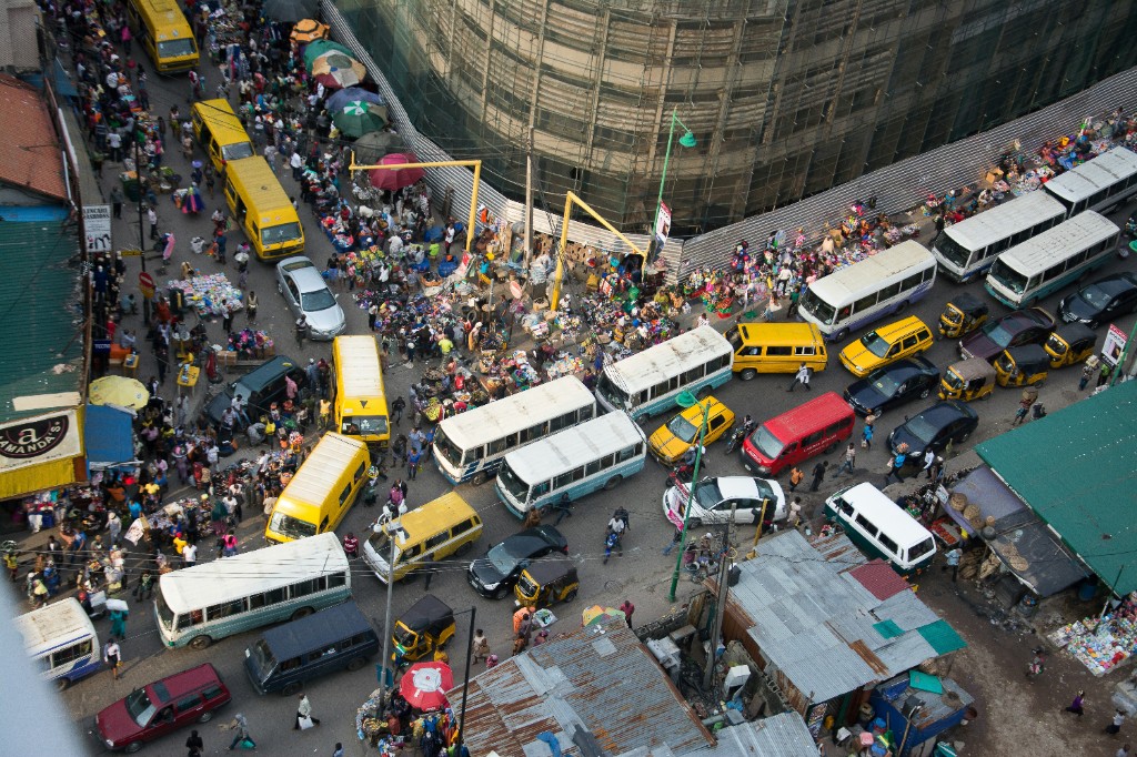 Bustling African city — keke, buses and street life